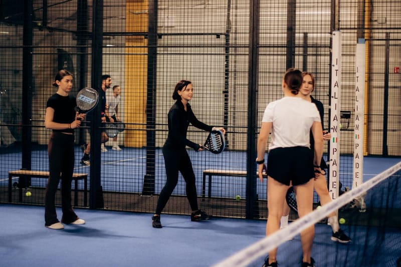Padel doubles players shaking hands at the net after a match